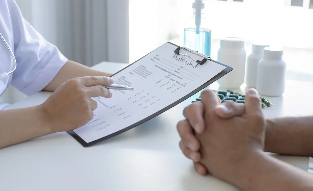 A practitioner reviewing intake notes with a client during an initial assessment