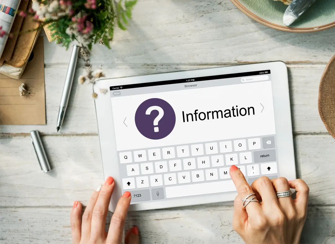 A person reading information about hypnotherapy on a tablet before booking a session